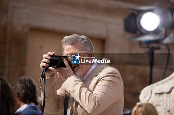 2023-06-19 - Director Chris McQuarrie takes pictures during the Red Carpet at the Global Premiere of Paramount Pictures' 