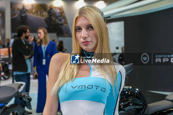 2023-11-07 - Model at VMoto electric bike stand at 80th edition of EICMA - Milan International Exhibition of Cycle and Motorcycle at Rho Fair on November 7, 2023, Rho - Milan, Italy. - EICMA - 80TH EDITION OF INTERNATIONAL CYCLE AND MOTORCYCLE EXHIBITION - NEWS - EVENTS