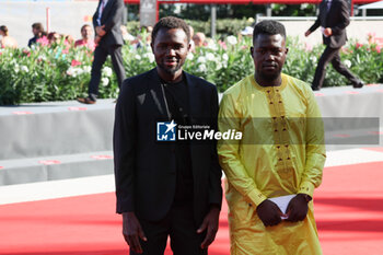 2023-09-06 - Mamadou Kouassi and a guest attend a red carpet for the movie 