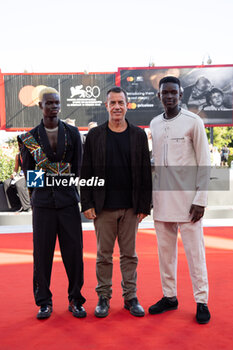 2023-09-06 - (R-L) Seydou Sarr, Matteo Garrone and Moustapha Fall attend a red carpet for the movie 