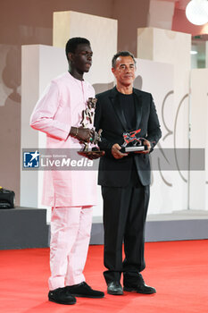 2023-09-09 - Seydou Sarr with the Marcello Mastroianni Award for Best New Young Actor or Actress, poses with Matteo Garrone, Silver Lion for ‘Io Capitano’ at the winner's photocall at the 80th Venice International Film Festival on September 09, 2023 in Venice, Italy. ©Photo: Cinzia Camela. - WINNERS PHOTOCALL - THE 80TH VENICE INTERNATIONAL FILM FESTIVAL - NEWS - VIP