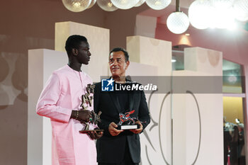 2023-09-09 - Seydou Sarr with the Marcello Mastroianni Award for Best New Young Actor or Actress, poses with Matteo Garrone, Silver Lion for ‘Io Capitano’ at the winner's photocall at the 80th Venice International Film Festival on September 09, 2023 in Venice, Italy. ©Photo: Cinzia Camela. - WINNERS PHOTOCALL - THE 80TH VENICE INTERNATIONAL FILM FESTIVAL - NEWS - VIP