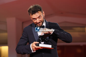 2023-09-09 - Enrico Maria Artale poses with the Best Screenplay Award for film 'El Paraiso' at the winner's photocall at the 80th Venice International Film Festival on September 09, 2023 in Venice, Italy. ©Photo: Cinzia Camela. - WINNERS PHOTOCALL - THE 80TH VENICE INTERNATIONAL FILM FESTIVAL - NEWS - VIP