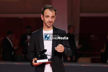 2023-09-09 - Erenik Beqiri poses with the Best Short Film Award for film 'A Short Trip' at the winner's photocall at the 80th Venice International Film Festival on September 09, 2023 in Venice, Italy. ©Photo: Cinzia Camela. - WINNERS PHOTOCALL - THE 80TH VENICE INTERNATIONAL FILM FESTIVAL - NEWS - VIP