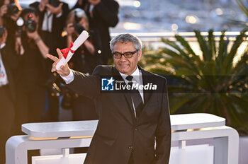 2024-05-25 - Mohammad Rasoulof poses with the 'Special Award for Best Screenplay' for 'The Seed of the Sacred Fig' during the Palme D'Or Winners Photocall at the 77th annual Cannes Film Festival at Palais des Festivals on May 25, 2024 in Cannes, France. - PALME D'OR WINNERS PHOTOCALL - THE 77TH ANNUAL CANNES FILM FESTIVAL - NEWS - CULTURE