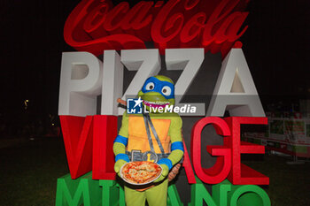 2024-09-06 - Logo of the event with Leonardo delle Tartarughe nija with pizza - COCA-COLA PIZZA VILLAGE MILAN - NEWS - EVENTS