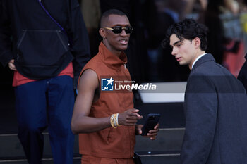 2024-06-16 - Alioune Badera and a guest leave the Prada Spring/Summer 2025 Menswear Fashion Show on June 16, 2024 in Milan, Italy.©Photo: Cinzia Camela. - PRADA - SS 25 - CELEBRITIES - NEWS - FASHION