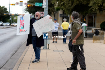 2024-11-05 - A passerby takes issue with a supporter of Democratic candidate for U.S. Senate Collin Allred who is holding signs against incumbent Ted Cruz (R-TX) outside the polling place at City Hall. - VOTING DAY - UNITED STATES PRESIDENTIAL ELECTION IN TEXAS - NEWS - POLITICS