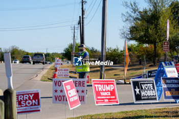 2024-11-05 - An election worker directs traffic into the parking lot of a polling place in the final hours of voting on Election Day. Voters across the state capital area were met with short lines at most polling places throughout the day, as more than 9 million Texans took advantage of the state’s early voting period. - VOTING DAY - UNITED STATES PRESIDENTIAL ELECTION IN TEXAS - NEWS - POLITICS