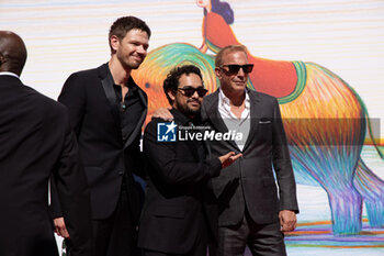 2024-09-07 - (L-R) Jon Beavers, Alejandro Edda and Kevin Costner attend the 