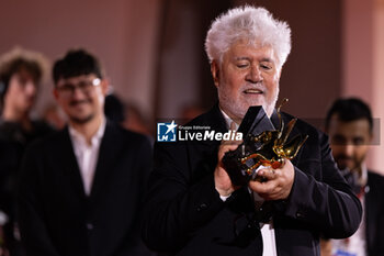 2024-09-07 - Pedro Almodovar poses with the golden Lion Award for The room next door