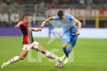 2021-09-28 - Yannick Ferreira Carrasco of Club Atletico de Madrid fights for the ball against Ismael Bennacer of AC Milan during the UEFA Champions League 2021/22 Group Stage - Group B football match between AC Milan and Club Atletico de Madrid at Giuseppe Meazza Stadium, Milan, Italy on September 28, 2021 - AC MILAN VS ATLETICO MADRID - UEFA CHAMPIONS LEAGUE - SOCCER