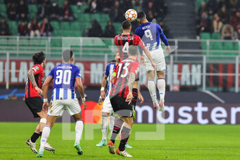 2021-11-03 - Mehdi Taremi of FC Porto fights for the ball against Ismael Bennacer of AC Milan during the UEFA Champions League 2021/22 Group Stage - Group B football match between AC Milan and FC Porto at Giuseppe Meazza Stadium, Milan, Italy on November 03, 2021 - AC MILAN VS FC PORTO - UEFA CHAMPIONS LEAGUE - SOCCER