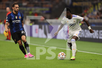 2021-09-15 - Vinícius Júnior of Real Madrid CF in action with Hakan Calhanoglu of FC Internazionale during the UEFA Champions League 2021/22 Group Stage - Group D football match between FC Internazionale and Real Madrid CF at Giuseppe Meazza Stadium, Milan, Italy on September 15, 2021 - GROUP D - INTER - FC INTERNAZIONALE VS REAL MADRID - UEFA CHAMPIONS LEAGUE - SOCCER