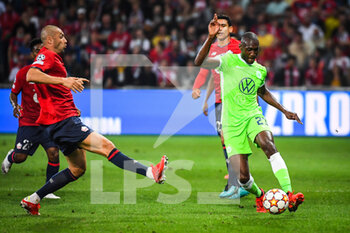 2021-09-14 - Burak YILMAZ of Lille and Josuha GUILAVOGUI of Wolfsburg during the UEFA Champions League, Group Stage, Group G football match between Lille OSC (LOSC) and Verein fur Leibesubungen Wolfsburg on September 14, 2021 at Pierre Mauroy Stadium in Villeneuve-d'Ascq, France - LILLE OSC (LOSC) AND VEREIN FUR LEIBESUBUNGEN WOLFSBURG - UEFA CHAMPIONS LEAGUE - SOCCER