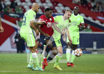 2021-09-14 - Jonathan David of Lille between John Brooks and Maximilian Arnold of Wolfsburg during the UEFA Champions League, Group Stage, Group G football match between Lille OSC (LOSC) and VfL Wolfsburg on September 14, 2021 at Stade Pierre Mauroy in Villeneuve-d?Ascq near Lille, France - LILLE OSC (LOSC) AND VEREIN FUR LEIBESUBUNGEN WOLFSBURG - UEFA CHAMPIONS LEAGUE - SOCCER