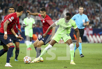 2021-09-14 - Dodi Lukebakio of Wolfsburg, Mehmet Zeki Celik of Lille (left) during the UEFA Champions League, Group Stage, Group G football match between Lille OSC (LOSC) and VfL Wolfsburg on September 14, 2021 at Stade Pierre Mauroy in Villeneuve-d?Ascq near Lille, France - LILLE OSC (LOSC) AND VEREIN FUR LEIBESUBUNGEN WOLFSBURG - UEFA CHAMPIONS LEAGUE - SOCCER
