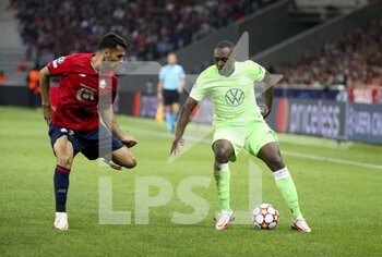 2021-09-14 - Jerome Roussillon of Wolfsburg, Mehmet Zeki Celik of Lille (left) during the UEFA Champions League, Group Stage, Group G football match between Lille OSC (LOSC) and VfL Wolfsburg on September 14, 2021 at Stade Pierre Mauroy in Villeneuve-d?Ascq near Lille, France - LILLE OSC (LOSC) AND VEREIN FUR LEIBESUBUNGEN WOLFSBURG - UEFA CHAMPIONS LEAGUE - SOCCER