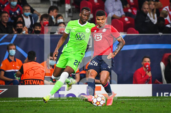 2021-09-14 - Dodi LUKEBAKIO of Wolfsburg and REINILDO of Lille during the UEFA Champions League, Group Stage, Group G football match between Lille OSC (LOSC) and Verein fur Leibesubungen Wolfsburg on September 14, 2021 at Pierre Mauroy Stadium in Villeneuve-d'Ascq, France - LILLE OSC (LOSC) AND VEREIN FUR LEIBESUBUNGEN WOLFSBURG - UEFA CHAMPIONS LEAGUE - SOCCER