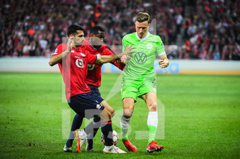 2021-09-14 - Zeki CELIK of Lille, Isaac LIHADJI of Lille and Yannick GERHARDT of Wolfsburg during the UEFA Champions League, Group Stage, Group G football match between Lille OSC (LOSC) and Verein fur Leibesubungen Wolfsburg on September 14, 2021 at Pierre Mauroy Stadium in Villeneuve-d'Ascq, France - LILLE OSC (LOSC) AND VEREIN FUR LEIBESUBUNGEN WOLFSBURG - UEFA CHAMPIONS LEAGUE - SOCCER