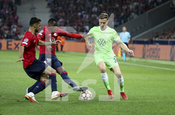 2021-09-14 - Yannick Gerhardt of Wolfsburg, left Mehmet Zeki Celik, Isaac Lihadji of Lille during the UEFA Champions League, Group Stage, Group G football match between Lille OSC (LOSC) and VfL Wolfsburg on September 14, 2021 at Stade Pierre Mauroy in Villeneuve-d?Ascq near Lille, France - LILLE OSC (LOSC) AND VEREIN FUR LEIBESUBUNGEN WOLFSBURG - UEFA CHAMPIONS LEAGUE - SOCCER