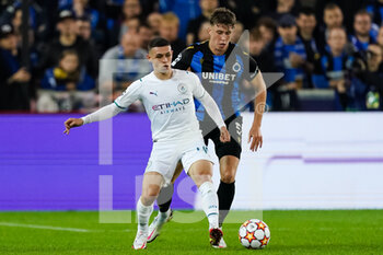 2021-10-19 - Phil Foden of Manchester City and Jack Hendry of Club Brugge during the UEFA Champions League, Group A football match between Club Brugge KV and Manchester City on October 19, 2021 at Jan Breydelstadion in Bruges, Belgium - CLUB BRUGGE KV VS MANCHESTER CITY - UEFA CHAMPIONS LEAGUE - SOCCER