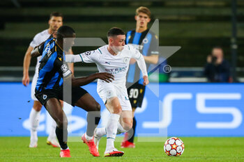 2021-10-19 - Stanley Nsoki of Club Brugge and Phil Foden of Manchester City during the UEFA Champions League, Group A football match between Club Brugge KV and Manchester City on October 19, 2021 at Jan Breydelstadion in Bruges, Belgium - CLUB BRUGGE KV VS MANCHESTER CITY - UEFA CHAMPIONS LEAGUE - SOCCER