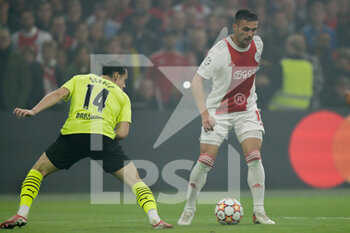 2021-10-19 - Dusan Tadic of Ajax, Nico Schulz of Borussia Dortmund during the UEFA Champions League, Group C football match between Ajax and Borussia Dortmund on October 19, 2021 at Johan Cruijff ArenA in Amsterdam, Netherlands - AJAX VS BORUSSIA DORTMUND - UEFA CHAMPIONS LEAGUE - SOCCER