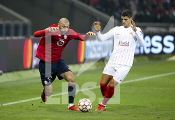 2021-10-20 - Burak Yilmaz of Lille, Erik Lamela of Sevilla FC during the UEFA Champions League, Group G football match between Lille OSC (LOSC) and Sevilla FC on October 20, 2021 at Stade Pierre Mauroy in Villeneuve-d'Ascq near Lille, France - LILLE OSC (LOSC) VS SEVILLA FC - UEFA CHAMPIONS LEAGUE - SOCCER