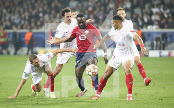 2021-10-20 - Jonathan Ikone of Lille between Ludwig Augustinsson, Thomas Delaney, Diego Carlos of Sevilla FC during the UEFA Champions League, Group G football match between Lille OSC (LOSC) and Sevilla FC on October 20, 2021 at Stade Pierre Mauroy in Villeneuve-d'Ascq near Lille, France - LILLE OSC (LOSC) VS SEVILLA FC - UEFA CHAMPIONS LEAGUE - SOCCER