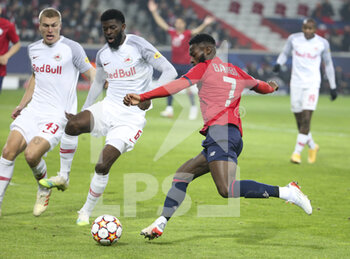 2021-11-23 - Jonathan Bamba of Lille, left Rasmus Kristensen, Jerome Onguene of RB Salzburg during the UEFA Champions League, Group G football match between Lille OSC (LOSC) and FC RB Salzburg on November 23, 2021 at Pierre Mauroy stadium in Villeneuve-d'Ascq near Lille, France - LILLE LOSC VS FC SALZBURG - UEFA CHAMPIONS LEAGUE - SOCCER