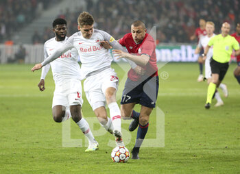 2021-11-23 - Maximilian Wober of RB Salzburg, Burak Yilmaz of Lille during the UEFA Champions League, Group G football match between Lille OSC (LOSC) and FC RB Salzburg on November 23, 2021 at Pierre Mauroy stadium in Villeneuve-d'Ascq near Lille, France - LILLE LOSC VS FC SALZBURG - UEFA CHAMPIONS LEAGUE - SOCCER