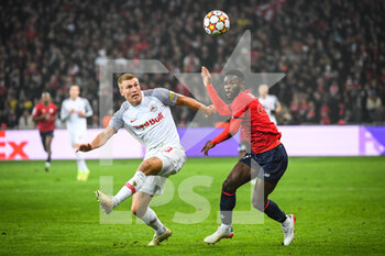 2021-11-23 - Rasmus KRISTENSEN of RB Salzbourg and Jonathan BAMBA of Lille during the UEFA Champions League, Group G football match between Lille LOSC and FC Salzburg on November 23, 2021 at Pierre Mauroy stadium in Villeneuve-d'Ascq near Lille, France - LILLE LOSC VS FC SALZBURG - UEFA CHAMPIONS LEAGUE - SOCCER