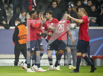 2021-11-23 - Jonathan David of Lille celebrates his goal with Burak Yilmaz (right) during the UEFA Champions League, Group G football match between Lille OSC (LOSC) and RB Salzburg on November 23, 2021 at Pierre Mauroy stadium in Villeneuve-d'Ascq near Lille, France - LILLE LOSC VS FC SALZBURG - UEFA CHAMPIONS LEAGUE - SOCCER