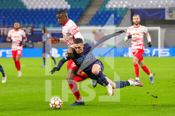 2021-12-07 - Phil Foden (47) of Manchester City is brought down by Nordi Mukiele (22) of RB Leipzig during the UEFA Champions League, Group A football match between RB Leipzig and Manchester City on December 7, 2021 at Red Bull Arena in Leipzig, Germany - RB LEIPZIG VS MANCHESTER CITY - UEFA CHAMPIONS LEAGUE - SOCCER
