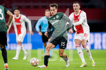 2021-12-07 - Manuel Ugarte of Sporting CP battles for the ball with Steven Berghuis of Ajax during the UEFA Champions League, Group C football match between Ajax and Sporting Clube de Portugal on December 7, 2021 at Johan Cruijff ArenA in Amsterdam, Netherlands - AJAX VS SPORTING CLUBE DE PORTUGAL - UEFA CHAMPIONS LEAGUE - SOCCER