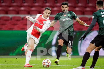 2021-12-07 - Antony of Ajax battles for the ball with Ricardo Esgaio of Sporting CP during the UEFA Champions League, Group C football match between Ajax and Sporting Clube de Portugal on December 7, 2021 at Johan Cruijff ArenA in Amsterdam, Netherlands - AJAX VS SPORTING CLUBE DE PORTUGAL - UEFA CHAMPIONS LEAGUE - SOCCER