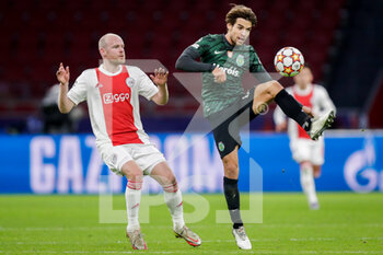 2021-12-07 - Davy Klaassen of Ajax battles for the ball with Daniel Braganca of Sporting CP during the UEFA Champions League, Group C football match between Ajax and Sporting Clube de Portugal on December 7, 2021 at Johan Cruijff ArenA in Amsterdam, Netherlands - AJAX VS SPORTING CLUBE DE PORTUGAL - UEFA CHAMPIONS LEAGUE - SOCCER