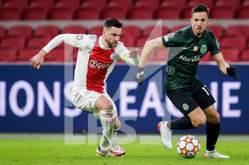 2021-12-07 - Nico Tagliafico of Ajax battles for the ball with Pablo Sarabia of Sporting CP during the UEFA Champions League, Group C football match between Ajax and Sporting Clube de Portugal on December 7, 2021 at Johan Cruijff ArenA in Amsterdam, Netherlands - AJAX VS SPORTING CLUBE DE PORTUGAL - UEFA CHAMPIONS LEAGUE - SOCCER