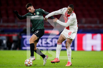 2021-12-07 - Goncalo Inacio of Sporting CP battles for the ball with Sebastien Haller of Ajax during the UEFA Champions League, Group C football match between Ajax and Sporting Clube de Portugal on December 7, 2021 at Johan Cruijff ArenA in Amsterdam, Netherlands - AJAX VS SPORTING CLUBE DE PORTUGAL - UEFA CHAMPIONS LEAGUE - SOCCER