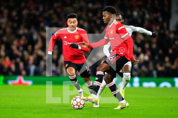 2021-12-08 - MANCHESTER, ENGLAND - DECEMBER 08: Anthony Elanga of Manchester United (R) controls the ball with Jesse Lingard of Manchester United (L) during the UEFA Champions League group F match between Manchester United and BSC Young Boys at Old Trafford on December 8, 2021 in Manchester, United Kingdom. - MANCHESTER UNITED VS BSC YOUNG BOYS - UEFA CHAMPIONS LEAGUE - SOCCER