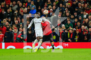 2021-12-08 - MANCHESTER, ENGLAND - DECEMBER 08: Nicolas Moumi Ngamaleu of Young Boys (L) fights for the ball against  Luke Shaw of Manchester United (R) during the UEFA Champions League group F match between Manchester United and BSC Young Boys at Old Trafford on December 8, 2021 in Manchester, United Kingdom. - MANCHESTER UNITED VS BSC YOUNG BOYS - UEFA CHAMPIONS LEAGUE - SOCCER
