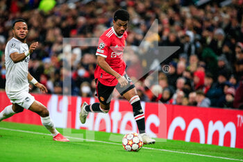 2021-12-08 - MANCHESTER, ENGLAND - DECEMBER 08: Amad Diallo of Manchester United (R) runs with the ball during the UEFA Champions League group F match between Manchester United and BSC Young Boys at Old Trafford on December 8, 2021 in Manchester, United Kingdom. - MANCHESTER UNITED VS BSC YOUNG BOYS - UEFA CHAMPIONS LEAGUE - SOCCER