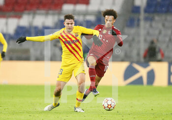 2021-12-08 - Nico Gonzalez of FC Barcelona and Leroy Sane of Bayern Munich during the UEFA Champions League, Group E football match between Bayern Munich and FC Barcelona on December 8, 2021 at Allianz Arena in Munich, Germany - BAYERN MUNICH VS FC BARCELONA - UEFA CHAMPIONS LEAGUE - SOCCER