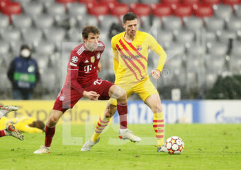 2021-12-08 - Thomas Muller of Bayern Munich and Clement Lenglet of FC Barcelona during the UEFA Champions League, Group E football match between Bayern Munich and FC Barcelona on December 8, 2021 at Allianz Arena in Munich, Germany - BAYERN MUNICH VS FC BARCELONA - UEFA CHAMPIONS LEAGUE - SOCCER