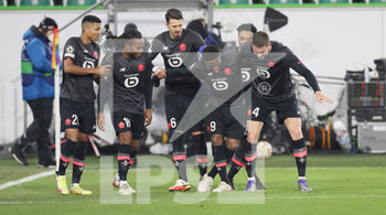 2021-12-08 - Jonathan David of Lille celebrates his goal 0-2 with teammates during the UEFA Champions League, Group G football match between VfL Wolfsburg and LOSC Lille on December 8, 2021 at Volkswagen Arena in Wolfsburg, Germany - VFL WOLFSBURG VS LOSC LILLE - UEFA CHAMPIONS LEAGUE - SOCCER