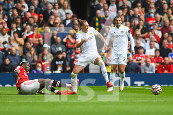2021-08-14 - Manchester United midfielder Paul Pogba (6) tackles Leeds United defender Luke Ayling (2) during the English championship Premier League football match between Manchester United and Leeds United on August 14, 2021 at Old Trafford in Manchester, England - Photo Malcolm Bryce / ProSportsImages / DPPI - MANCHESTER UNITED VS LEEDS UNITED - ENGLISH PREMIER LEAGUE - SOCCER