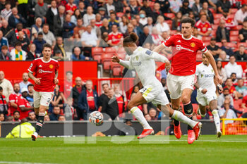 2021-08-14 - Manchester United defender Harry Maguire (5) tackles Leeds United forward Tyler Roberts (11) during the English championship Premier League football match between Manchester United and Leeds United on August 14, 2021 at Old Trafford in Manchester, England - Photo Malcolm Bryce / ProSportsImages / DPPI - MANCHESTER UNITED VS LEEDS UNITED - ENGLISH PREMIER LEAGUE - SOCCER
