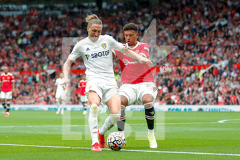 2021-08-14 - Jadon Sancho of Manchester United and Leeds United defender Luke Ayling during the English championship Premier League football match between Manchester United and Leeds United on August 14, 2021 at Old Trafford in Manchester, England - Photo Simon Davies / ProSportsImages / DPPI - MANCHESTER UNITED VS LEEDS UNITED - ENGLISH PREMIER LEAGUE - SOCCER