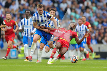 2021-08-21 - Adam Webster (4) of Brighton & Hove Albion brings down Emmanuel Dennis (25) of Watford during the English championship Premier League football match between Brighton and Hove Albion and Watford on August 21, 2021 at the American Express Community Stadium in Brighton and Hove, England - Photo Nigel Keene / ProSportsImages / DPPI - BRIGHTON AND HOVE ALBION VS WATFORD - ENGLISH PREMIER LEAGUE - SOCCER